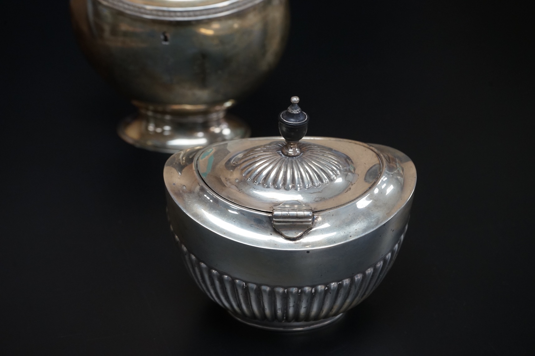 A late Victorian demi-fluted oval tea caddy, by William Hutton & Sons, London, 1894, width 11.1cm, together with a 19th century continental white metal oval tea caddy, possibly French, no key.